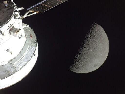 This handout picture released by NASA on April 7, 2026, shows the Orion spacecraft (L) and the Moon (R) on April 6, 2026