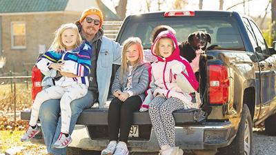 Travis Slate, of Imperial, awaits the 2022 Kimmswick Christmas Parade with his three daughters, Theodora, 5, Lorelei, 7, and Scarlett, 9, as well as their dog, Sheldon.