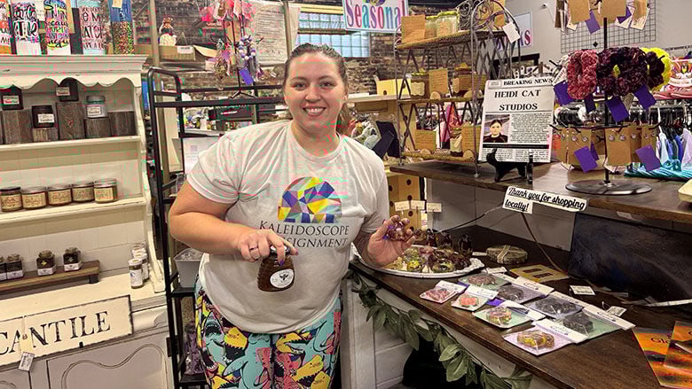 Kaleidoscope Consignment & Boutique co-owner Christine Slusser poses in the vendor section, which has handmade items for Valentine’s Day.