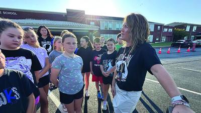 Megan Mahue, a fifth-grade teacher at Hillsboro Intermediate School, explains the significance of the school district's POW/MIA vigil to her students on Sept. 18.