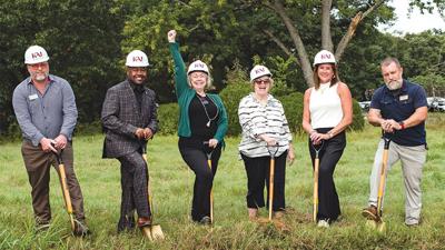 Dedee Lhamon, founder of The Covering House, raises an arm in celebration of the recent groundbreaking for the campus being built in Jefferson County.