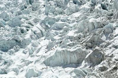 Climbers must cross the Khumbu icefall, a constantly shifting maze of crevasses and ice blocks, to reach higher on Mount Everest