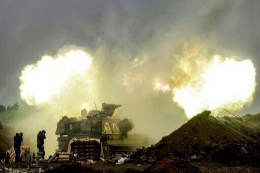 An Israeli self-propelled howitzer artillery gun fires rounds towards southern Lebanon