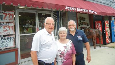 From left, John and Judy Kolisch, the mom and dad who started the business, and son Tom Kolisch in front of the John’s Butcher Shoppe, 503 N. Mill St., Festus.