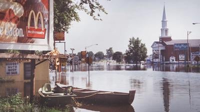 Boats are docked on a flooded Truman Boulevard in Crystal City, with a view of the First Baptist Church of Festus.