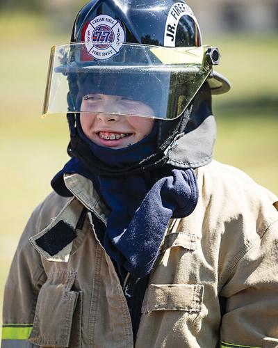 Dominic Hall, 12, of Dittmer tries on fire protection equipment.