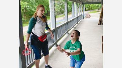 Tess and son Griffin, 7, having fun with bubbles at the Autism Adventure Day Camp in Summer 2024.