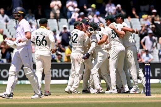 Australia players celebrate after taking the last England wicket