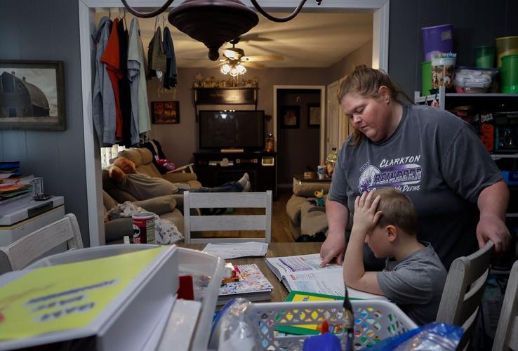 Former teacher and stay-at-home mom Melissa Johnson helps her son