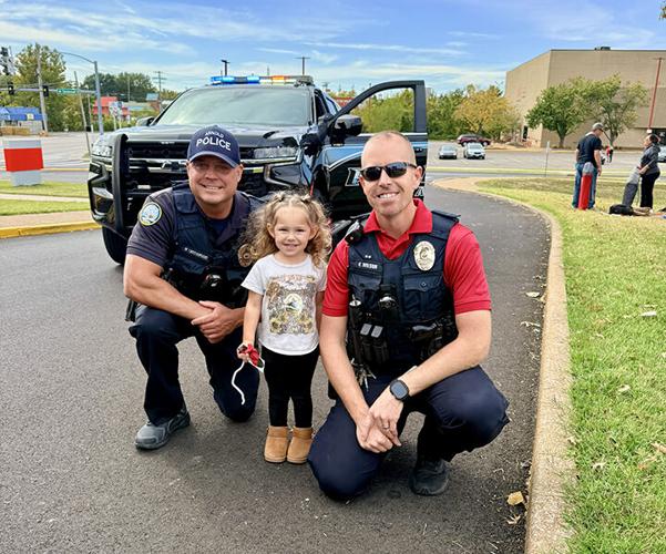 Arnold Police officers Mike Prusinowski, left, and Kevin Wilson, right, with Acie Cardona, the granddaughter of Fox C-6 School District Assistant Superintendent for Secondary Education Tammy Cardona, during this year’s homecoming parade. Prusinowski and...
