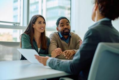 Young couple having consultations with their financial advisor in the office.