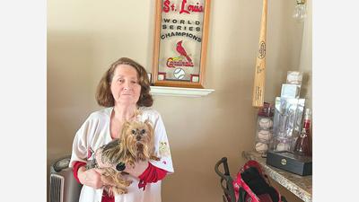 Jeanne Johnson holds her 5-year-old Yorkie, Yadi. She loves horses, dogs and the St. Louis Cardinals.