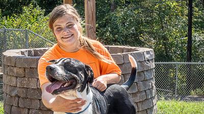 Oksana Murray of Arnold has volunteered with Open Door Animal Sanctuary in House Springs for two years, spending time with animals like Cool Hand Luke, seen above.