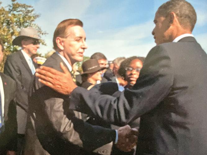 Heddell talks to then-President Barack Obama prior to Heddell’s retirement in 2012.