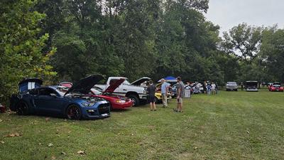 Attendees take a look at the cars on display at the House Springs Lions Car, Truck & Bike Show on Sept. 13.