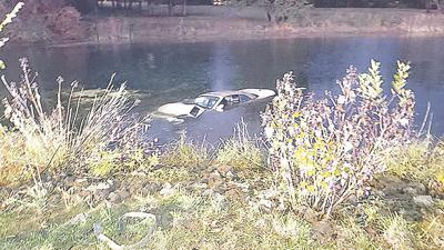 Firefighters rescued a woman from this car submerged in a pond near Six Flags.