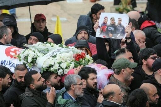 Mourners carry the body of one of the three journalists killed