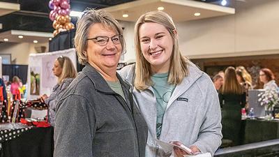 From left, Cheryl Mann of Festus and Kara Gray of Fenton gather information for an out-of-town bride at the 2022 Wedding Fair. This year’s fair will be held Feb. 5 at the Corpus Christi Event Center at St. Joseph Catholic Church in Imperial.