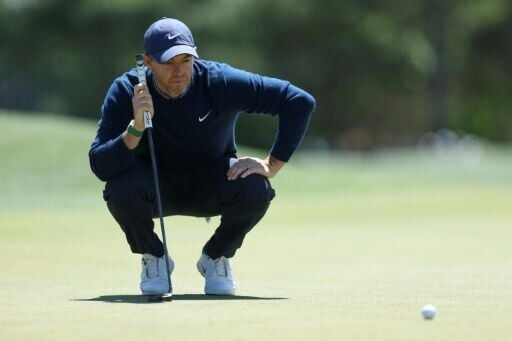 World number two Rory McIlroy lines up a putt on the eighth green during the first round of the 90th Masters