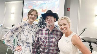 Noah Wangler, a Kirkwood resident who is the first graduate of the StepUp program, reunites with his former teachers, Emma Seyffert, left, and Cat Woerner during the StepUp kickoff on April 20 at Pupillo’s Banquet and Event Center in High Ridge.