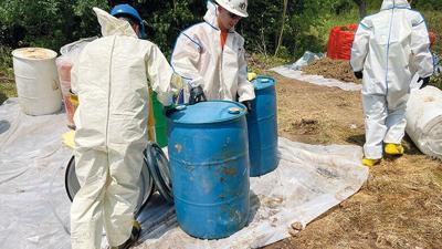 United States Environmental Protection Agency contractors right abandoned drums discovered on a Hillsboro-area property.