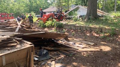 Cedar HIll firefighters work to free a man from rubble after a building he was demolishing collapsed on him.