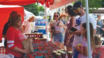 Chris Leach, owner of Imperial Farmers Market, and her sister, Gina Viviano, sell fresh strawberries during last year’s Kimmswick Strawberry Festival.