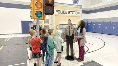Students line up at a streetlight to listen to a St. Louis Children’s Hospital Safety Street program instructor at Cedar Springs Elementary in House Springs.