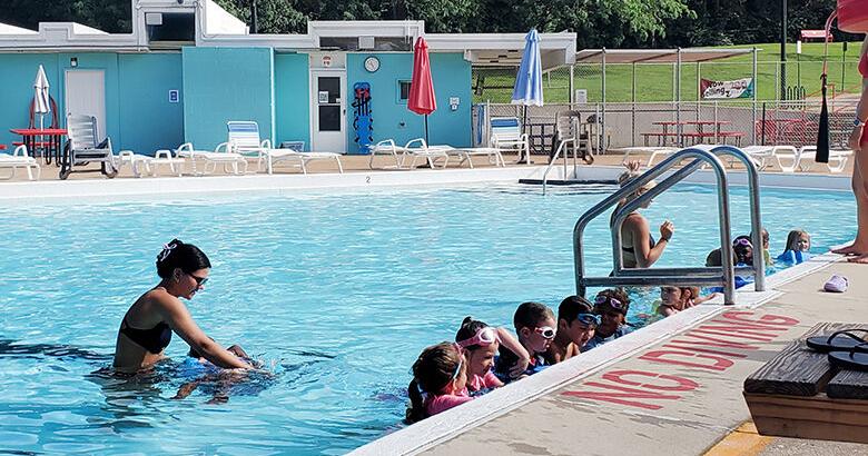 Children line up in the Crystal City Pool for a group swim class.
