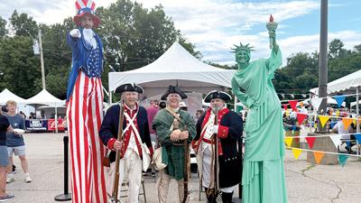 Stilt walkers from Circus Kaput and National Sons of the American Revolution members were available to take pictures with on June 27 at the Arnold Independence Day Celebration at Arnold City Park.