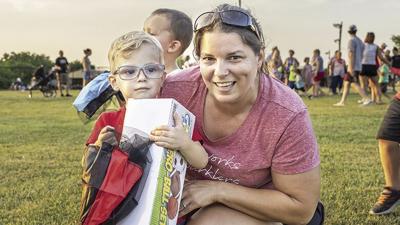 Nolan Kovalaske, 2 1/2, of Herculaneum, who caught a parachute to win a prize of several sports balls, with grandma Sarah Montgomery at the Hillsboro July Fourth fireworks event.
