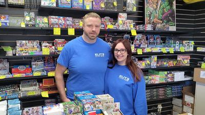 Ryan Graham, who owns Elite Collectibles, and his girlfriend, Julia Althage, who works at the store, show off some of the new cards available at 1258 Imperial Main St. in Imperial.