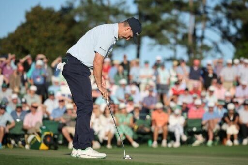 England's Justin Rose putts on the 18th green during the first round of the Masters