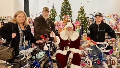 Tim and Karen Clark and granddaughter Gabrianah Marcus donate three bikes.