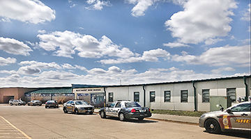 Police vehicles line up at Northwest High School after a student allegedly made a bomb threat.