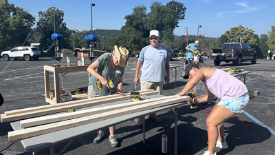 Sleep in Heavenly Peace members work to assemble a bunk bed in The River at Eureka parking lot.