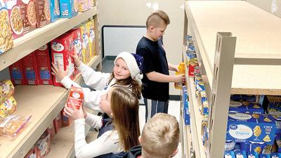 Telegraph Intermediate School students stock supplies in the new Jay Mart.