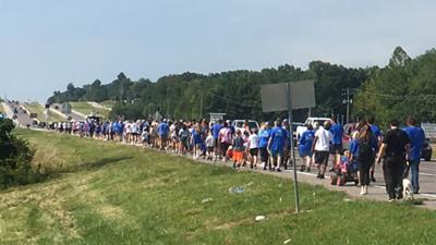 Participants in the 2022 Walking for Our Children event make their way to Chapel Hill Mortuary from Northwest High School.