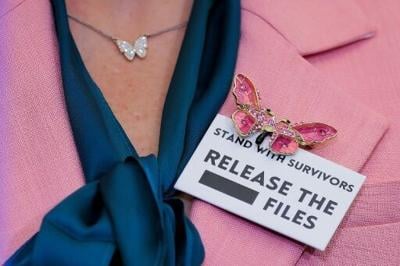 Danielle Bensky, a Jeffrey Epstein survivor, wears a butterfly pin and a 'release the files' badge during an event ahead of President Donald Trump's State of the Union speech