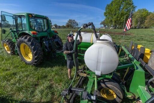 Russell Hedrick, a farmer in North Carolina, prepares a fertilizer blend to be sprayed on his fields as they are being seeded