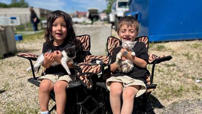 Calista, 3, and Xauer Sanford, 5, of De Soto snuggle with kittens at the petting zoo during Head Start’s 60th birthday celebration on May 17 at the Jefferson Franklin Community Action Corporation’s Hillsboro office.