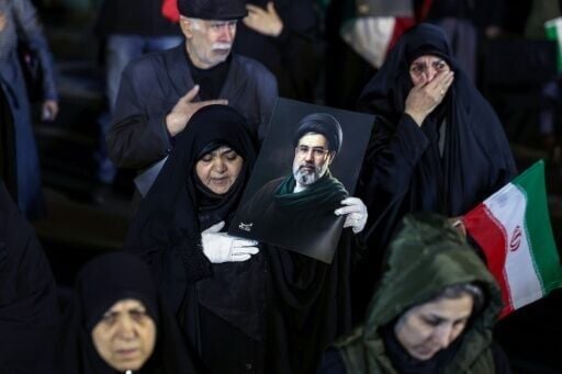 People held portraits of Iran's supreme leader Mojtaba Khamenei at a march to support the armed forces in Tehran on Thursday