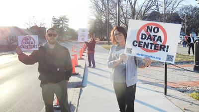 Ryan Skiera and Kelly Hall, both of Festus, protest a potential data center before a special meeting on Feb. 26.