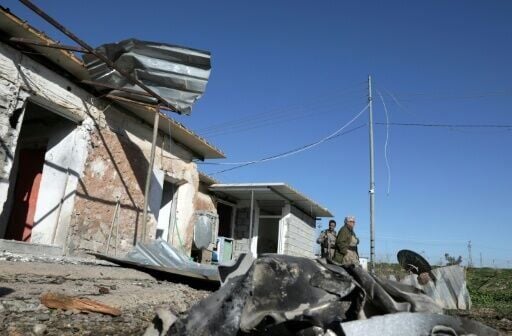 A member of the Kurdistan Democratic Party of Iran (KDPI) inspects damage after an Iranian attack in the Arbil district in the autonomous Kurdish region of northern Iraq