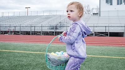 Elsie McCraw, 2, of Arnold collects Easter eggs during the 2023 Arnold Chamber of Commerce Eggstravaganza