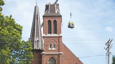 Crews remove the steeple from the Immaculate Conception Church during part of the demolition process on Aug. 28.