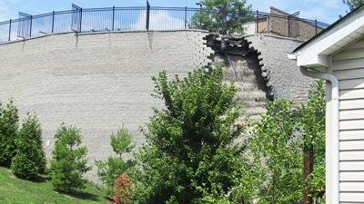 A portion of this retaining wall behind four businesses on Jeffco Boulevard in Arnold collapsed Wednesday morning.