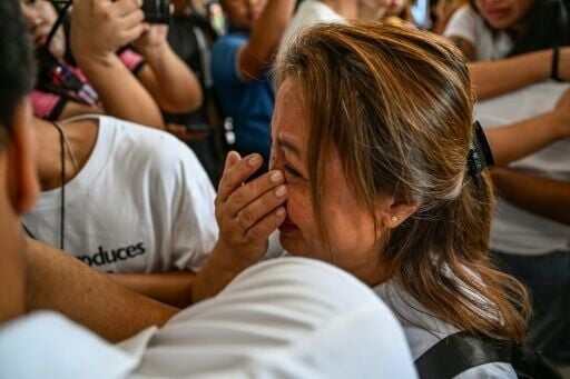 Lala Cumpio, mother of the detained Filipino journalist Frenchie Mae Cumpio, cries outside the Tacloban regional court after hearing the verdict