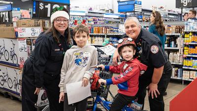 Amy Brielmaier, left, and Nichole O’Harver of Jefferson County 911 Dispatch shop with brothers, Ryder, 8, and Mason, 6, of Crystal City at the Jeffco Shop with a Cop event.