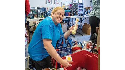 Tasha Peterson of Dittmer shops for gifts for four foster teenagers.